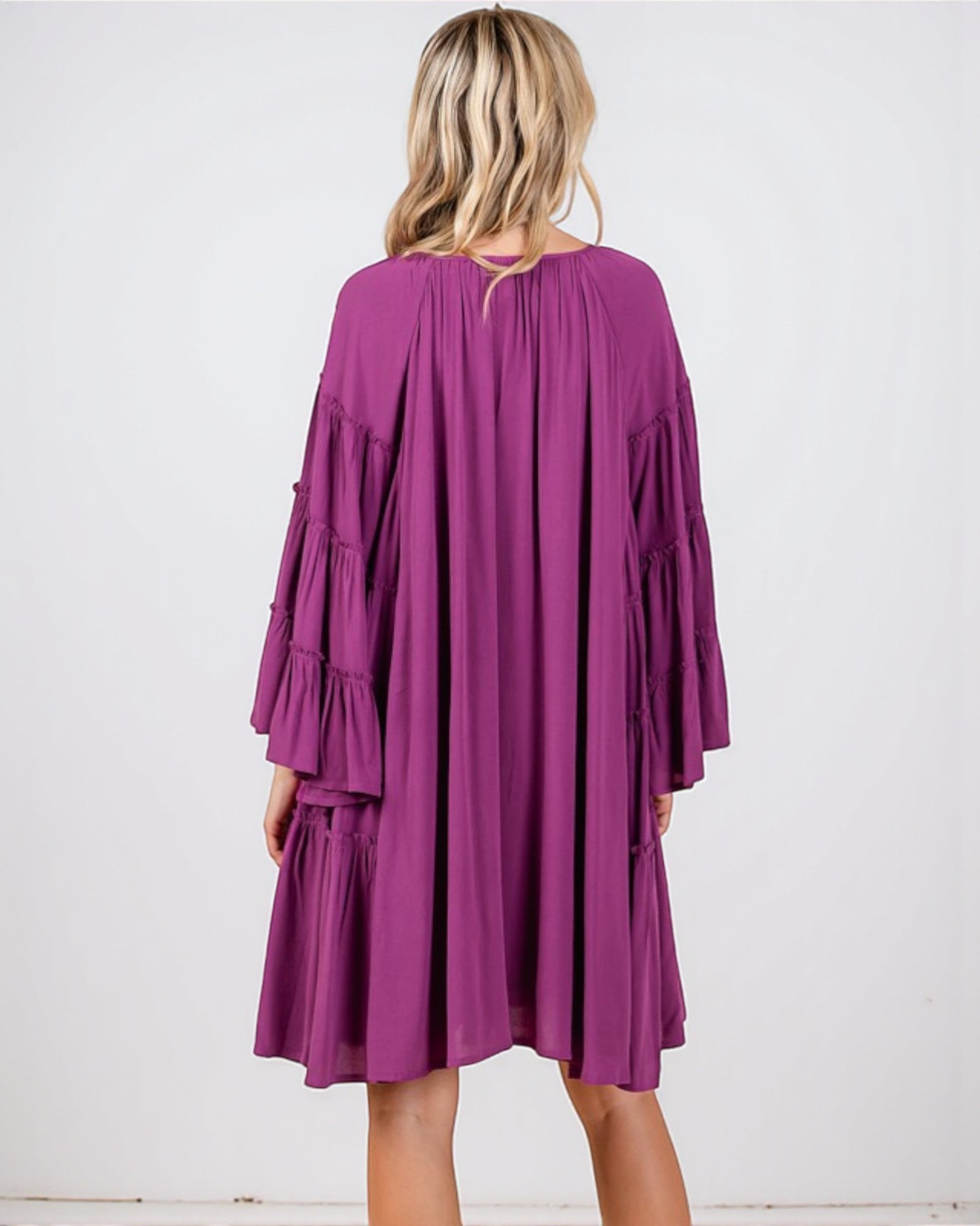 Purple dress worn by a person on a white background