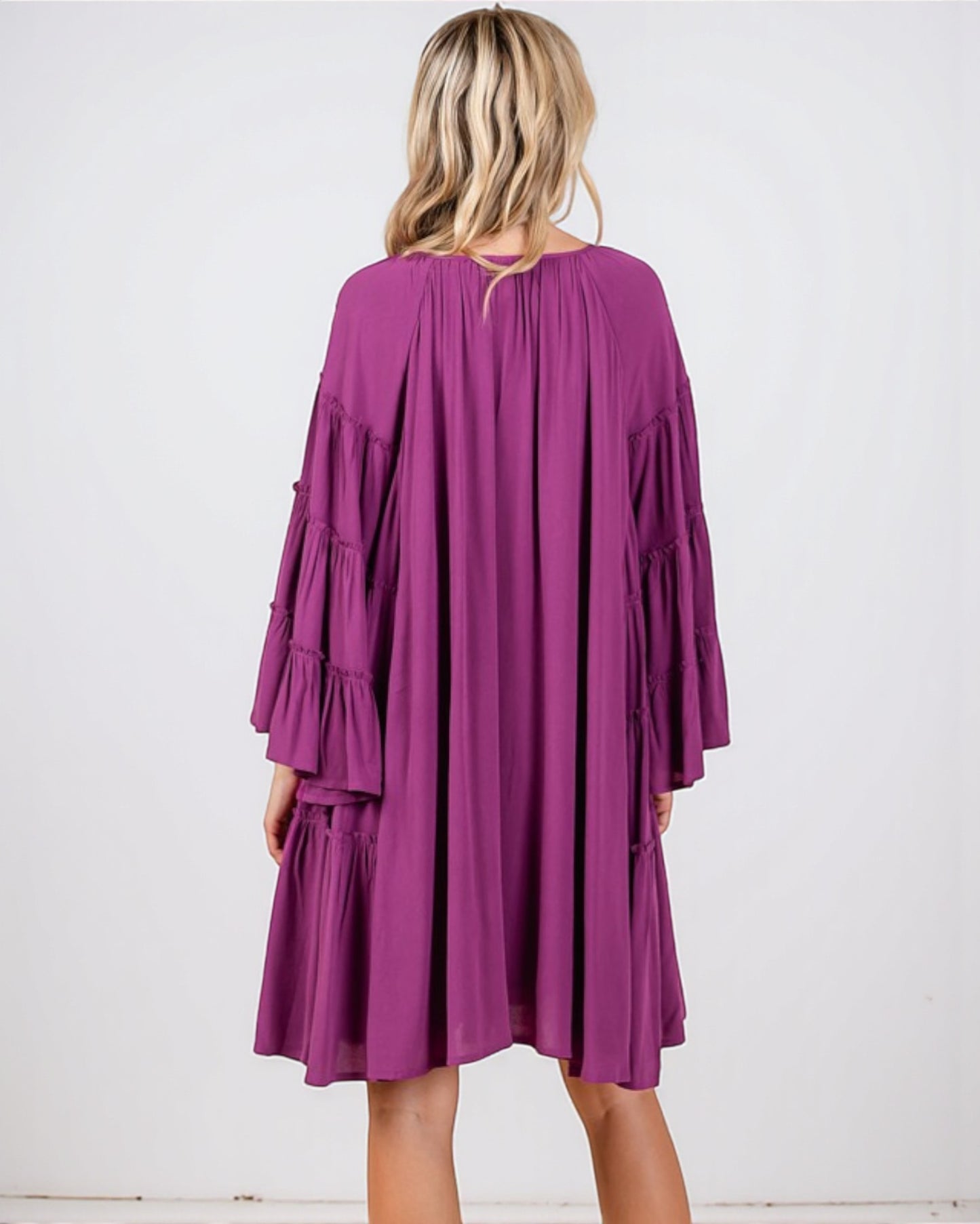 Purple dress worn by a person on a white background