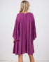 Purple dress worn by a person on a white background