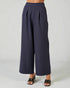 Navy wide-leg pants worn by a person on a light gray background