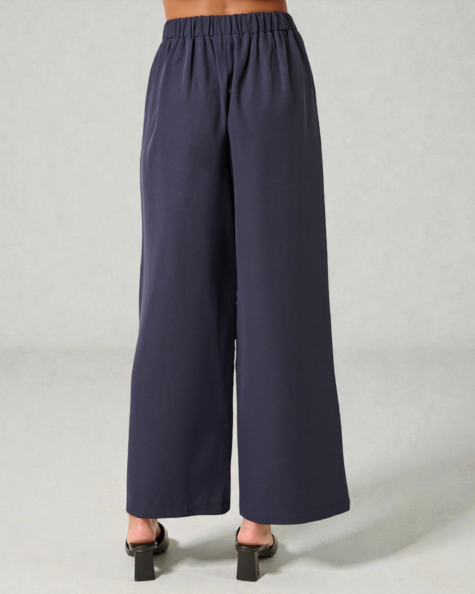 Navy wide-leg pants on a plain background