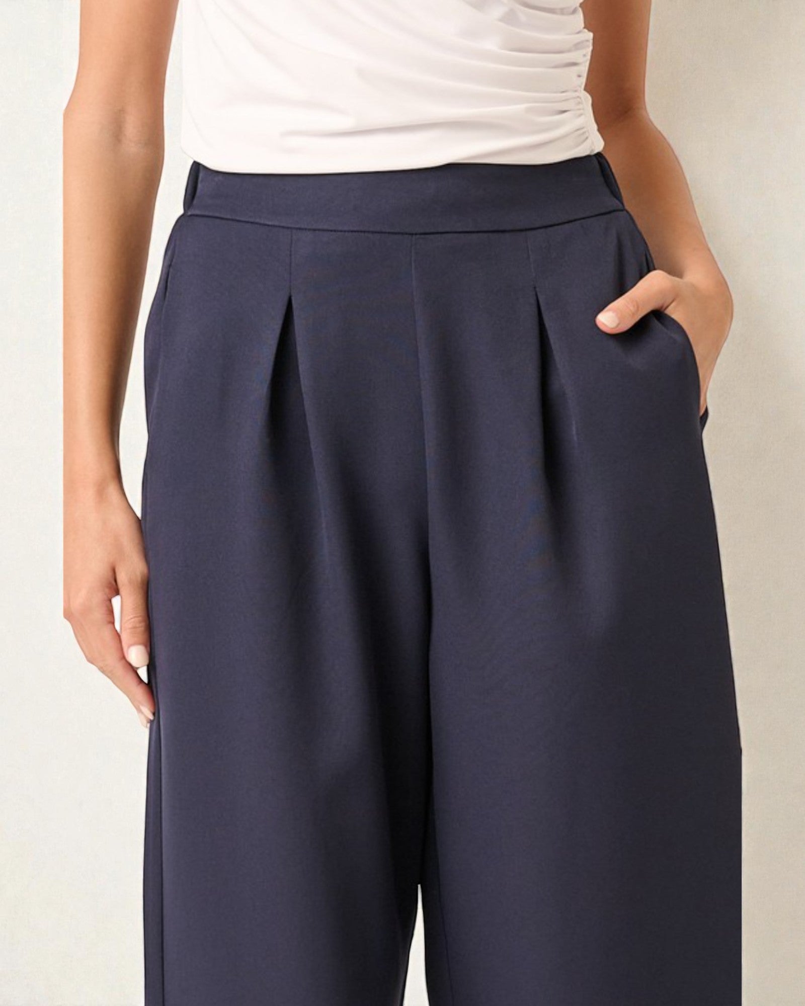 Navy blue wide-leg pants worn by a person on a plain background