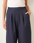 Navy blue wide-leg pants worn by a person on a plain background