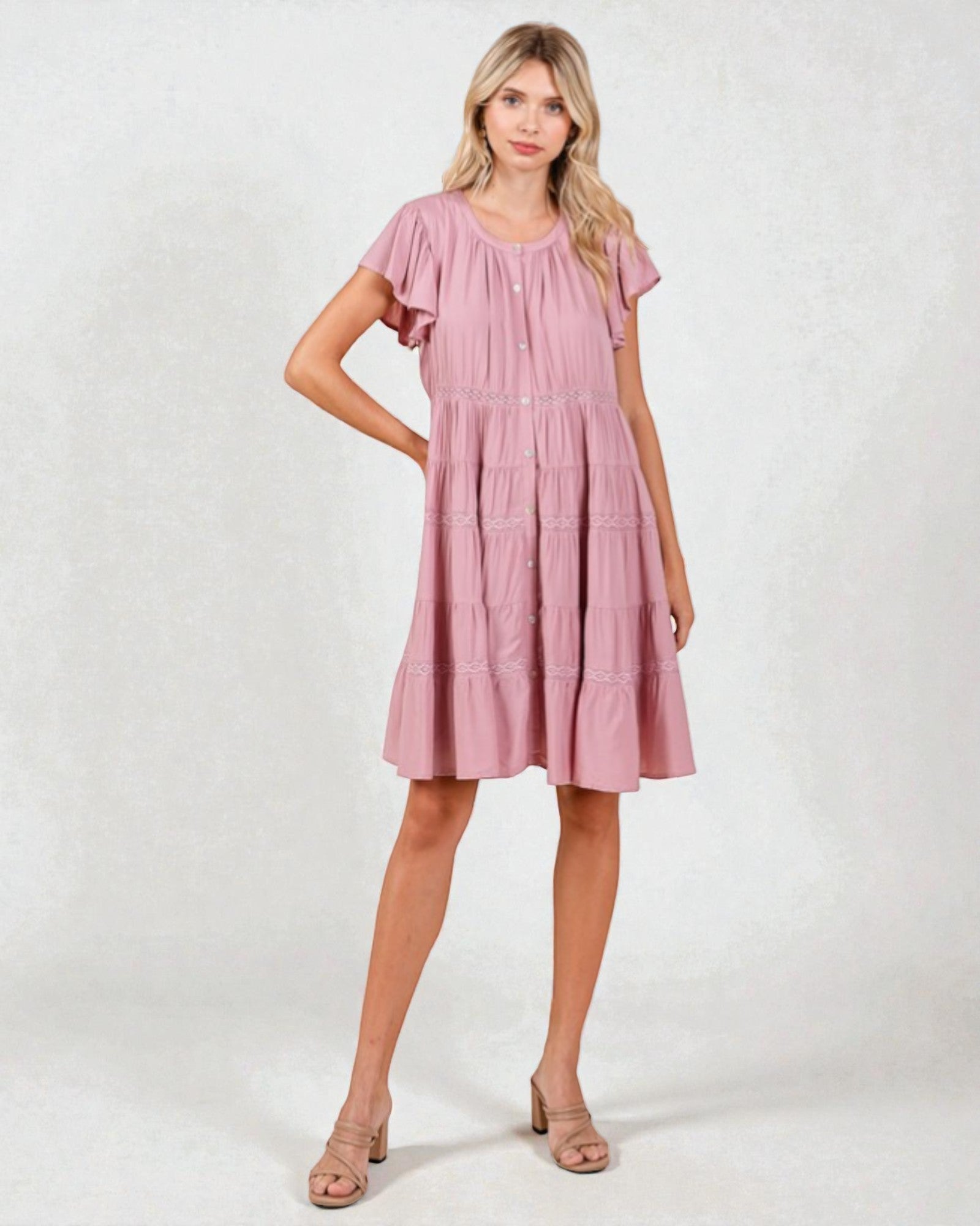 Woman wearing a pink dress on a white background