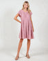 Woman wearing a pink dress on a white background