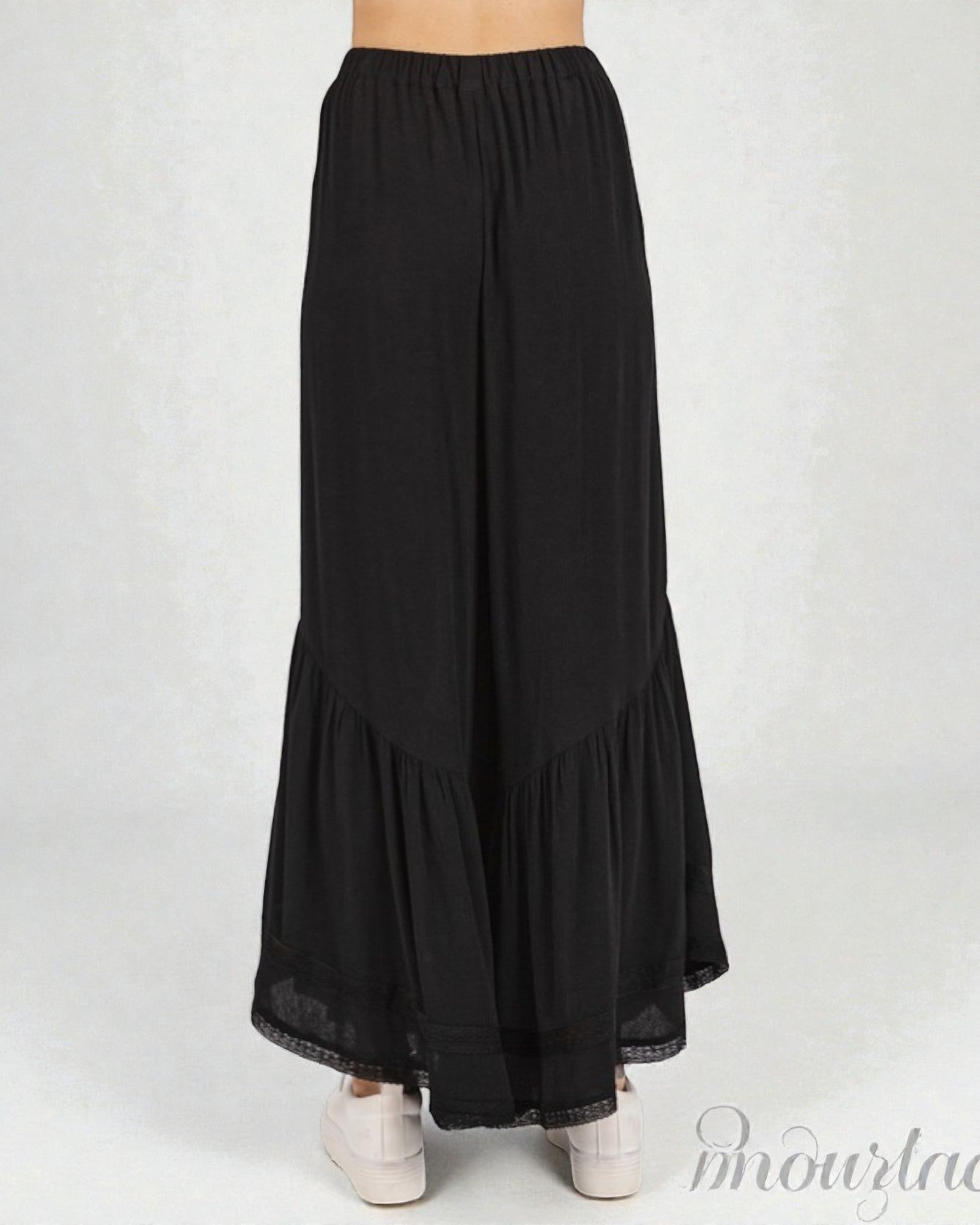 Black long skirt with ruffled hem on a white background