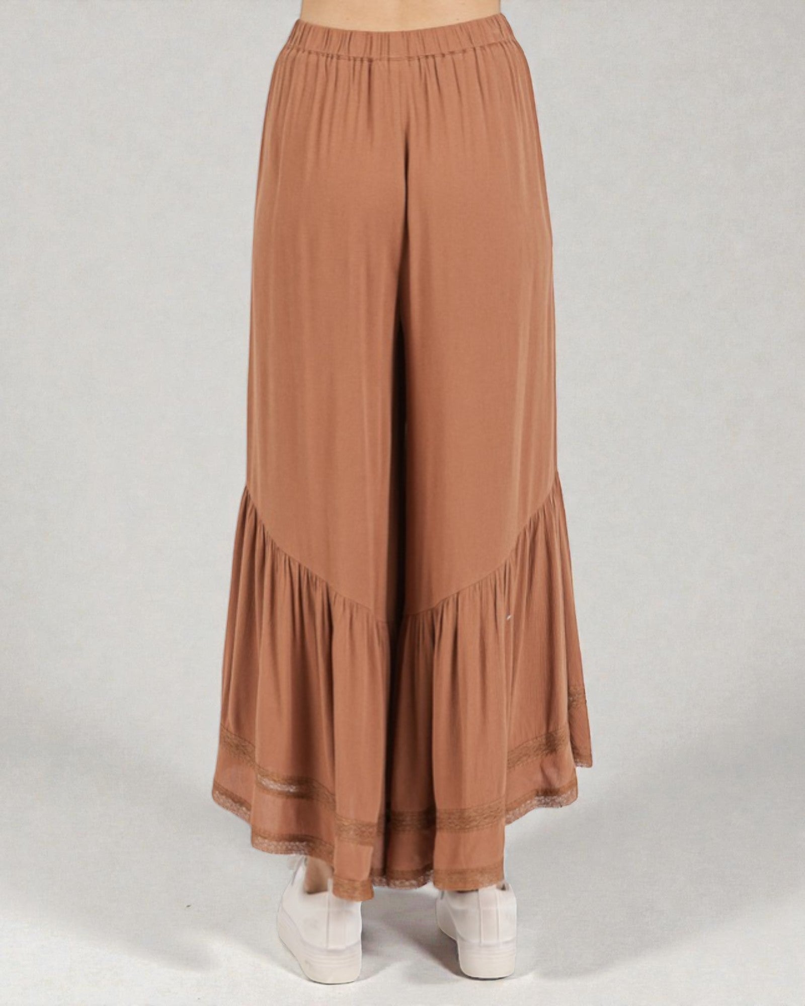 Brown wide-leg pants with ruffled bottom on a white background
