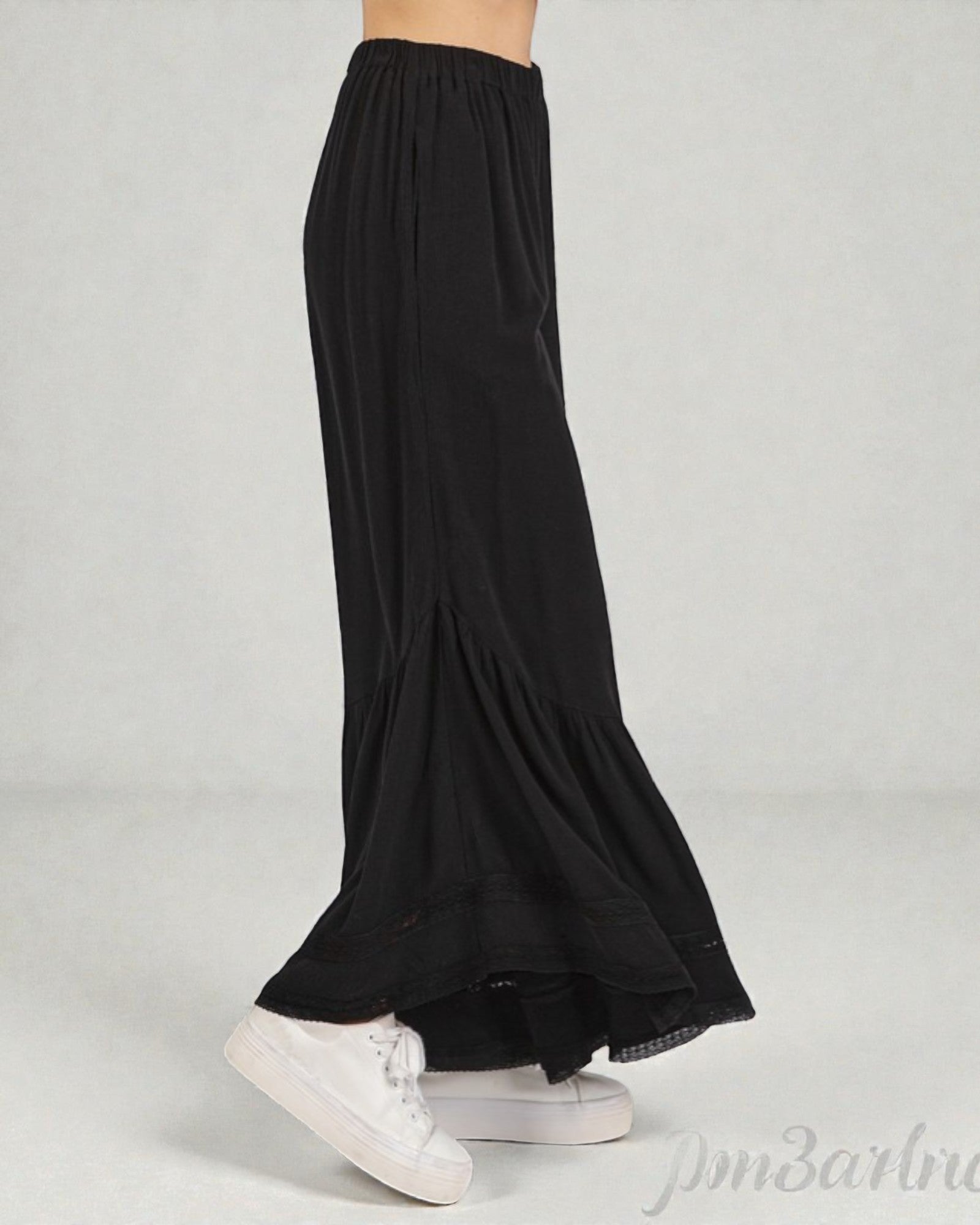 Black wide-leg pants worn by a person on a light gray background