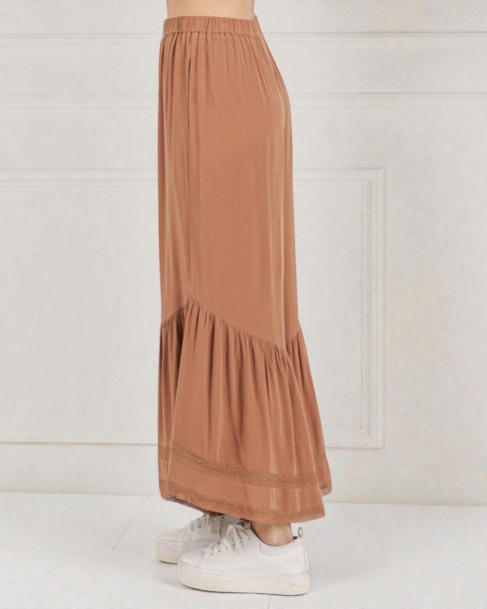 Brown tiered skirt worn by a person on a white background