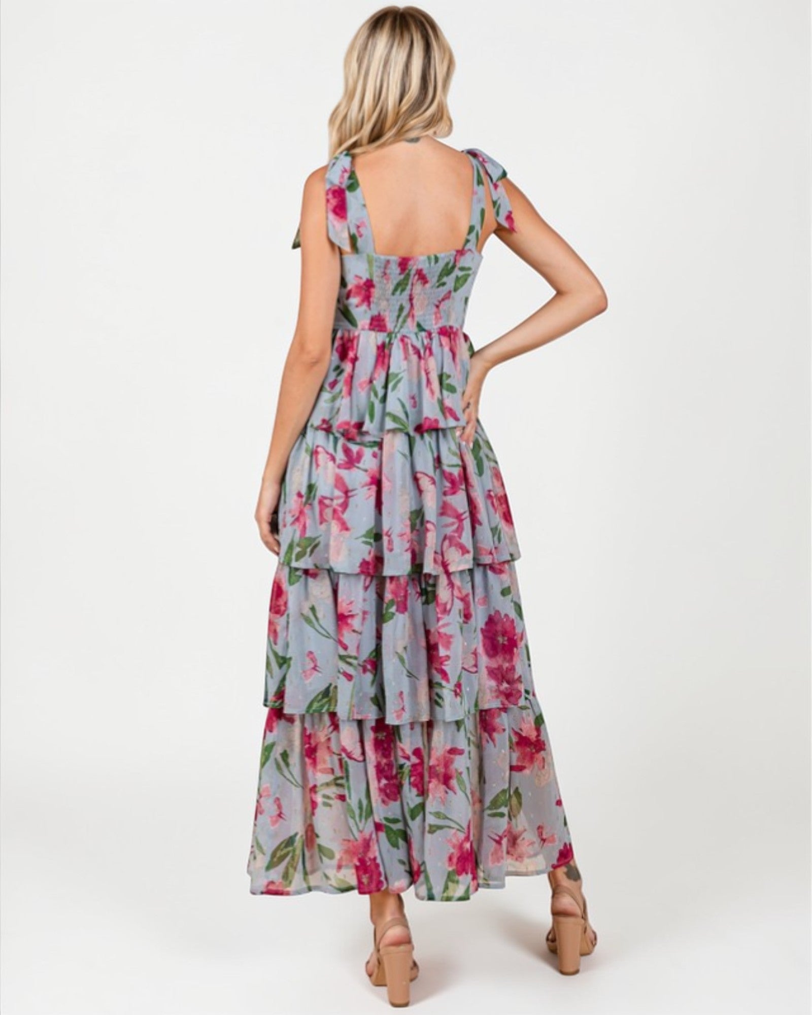 Woman wearing a floral dress with a white background