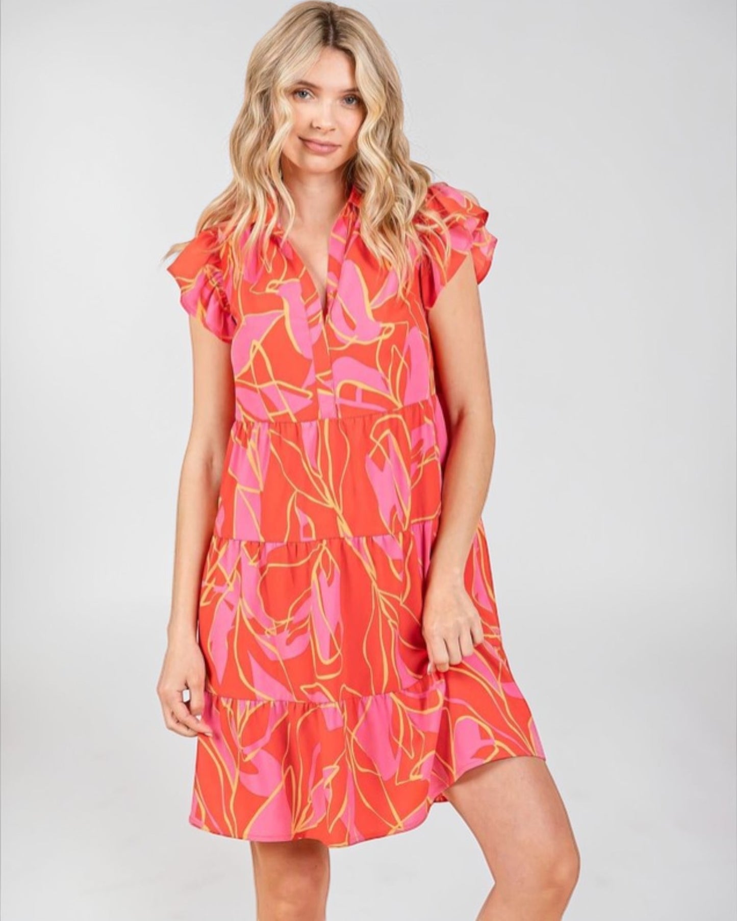 Woman wearing a colorful dress with a white background