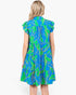 A woman viewed from the back wearing a tiered short-sleeve dress with a bright blue and green tropical leaf print, set against a plain white background.