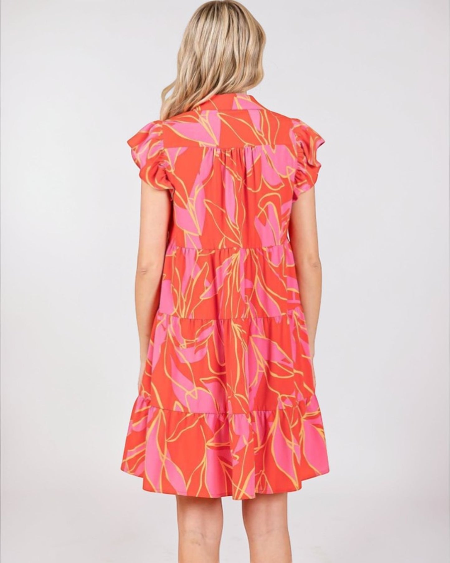 Woman wearing a colorful dress with a white background