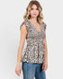 Woman wearing a leopard print top and jeans on a white background