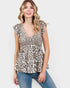 Woman wearing a leopard print top and jeans on a white background