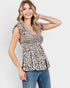 Woman wearing a leopard print top and jeans on a white background