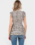 Woman wearing a leopard print top and blue jeans on a white background
