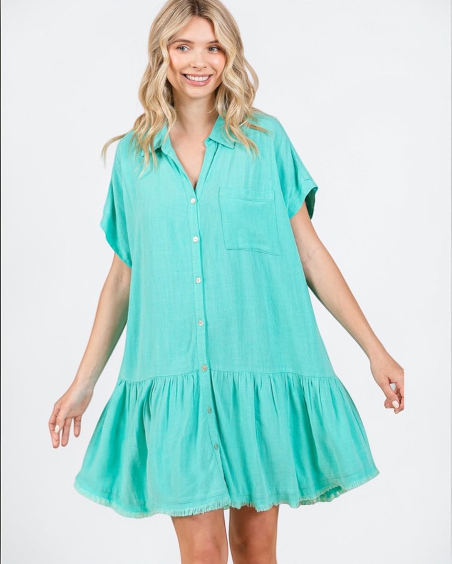 Woman wearing a turquoise dress on a white background