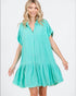 Woman wearing a turquoise dress on a white background