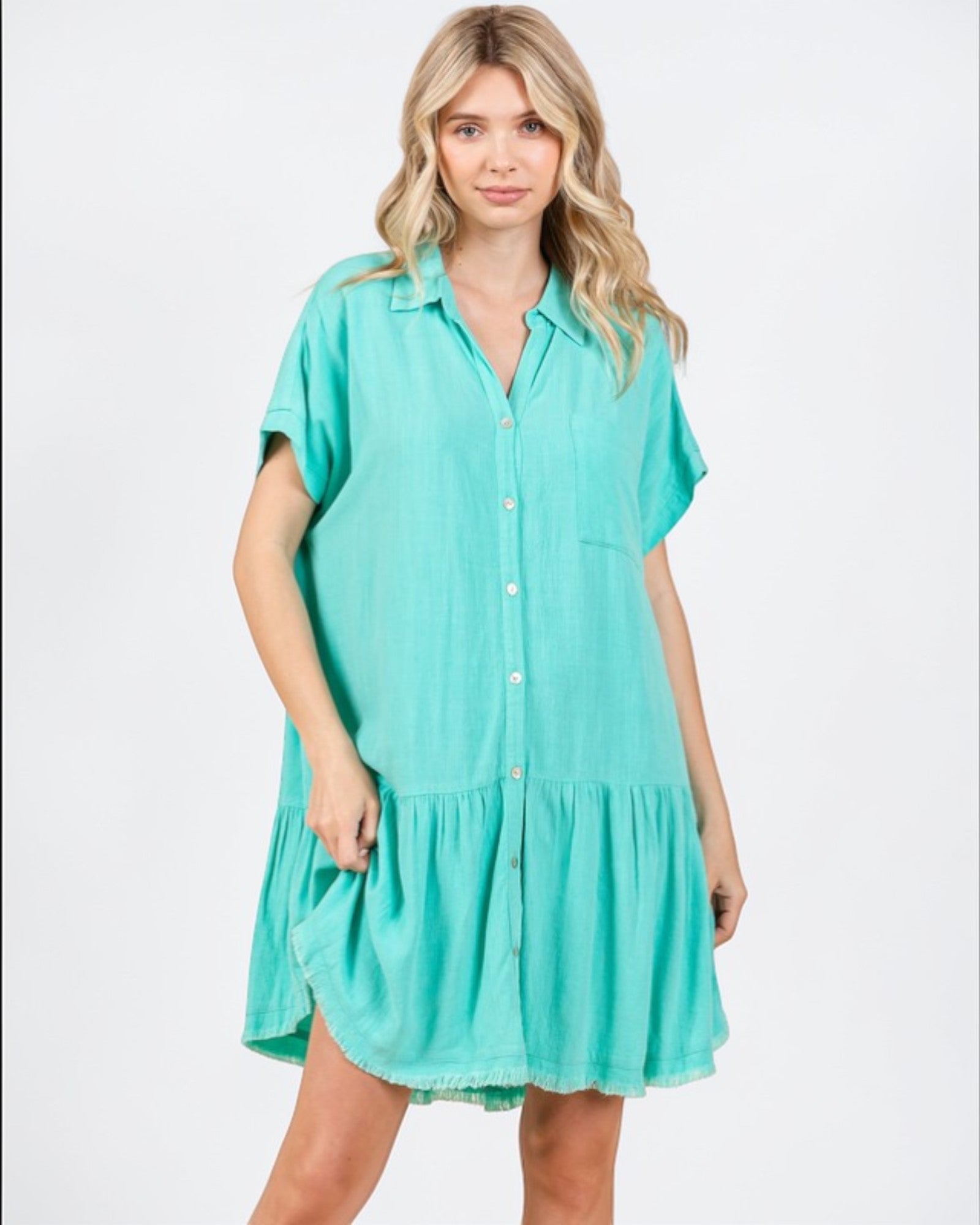 Woman wearing a turquoise dress on a white background