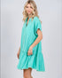 Woman wearing a teal dress on a white background