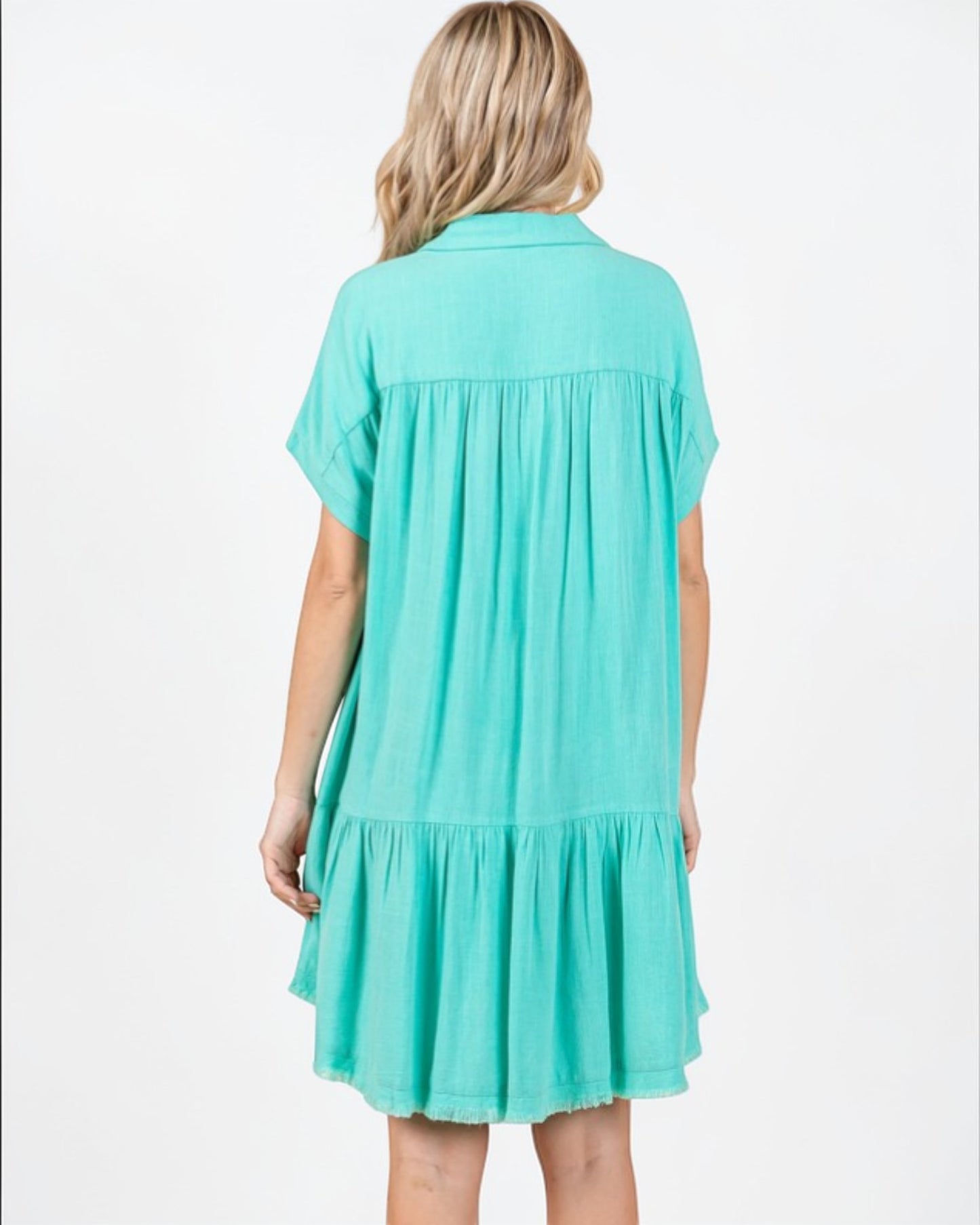 Woman wearing a turquoise dress on a white background