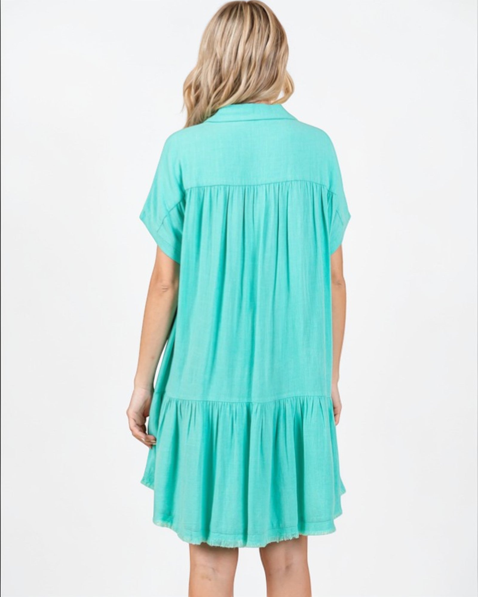 Woman wearing a turquoise dress on a white background