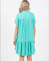 Woman wearing a turquoise dress on a white background