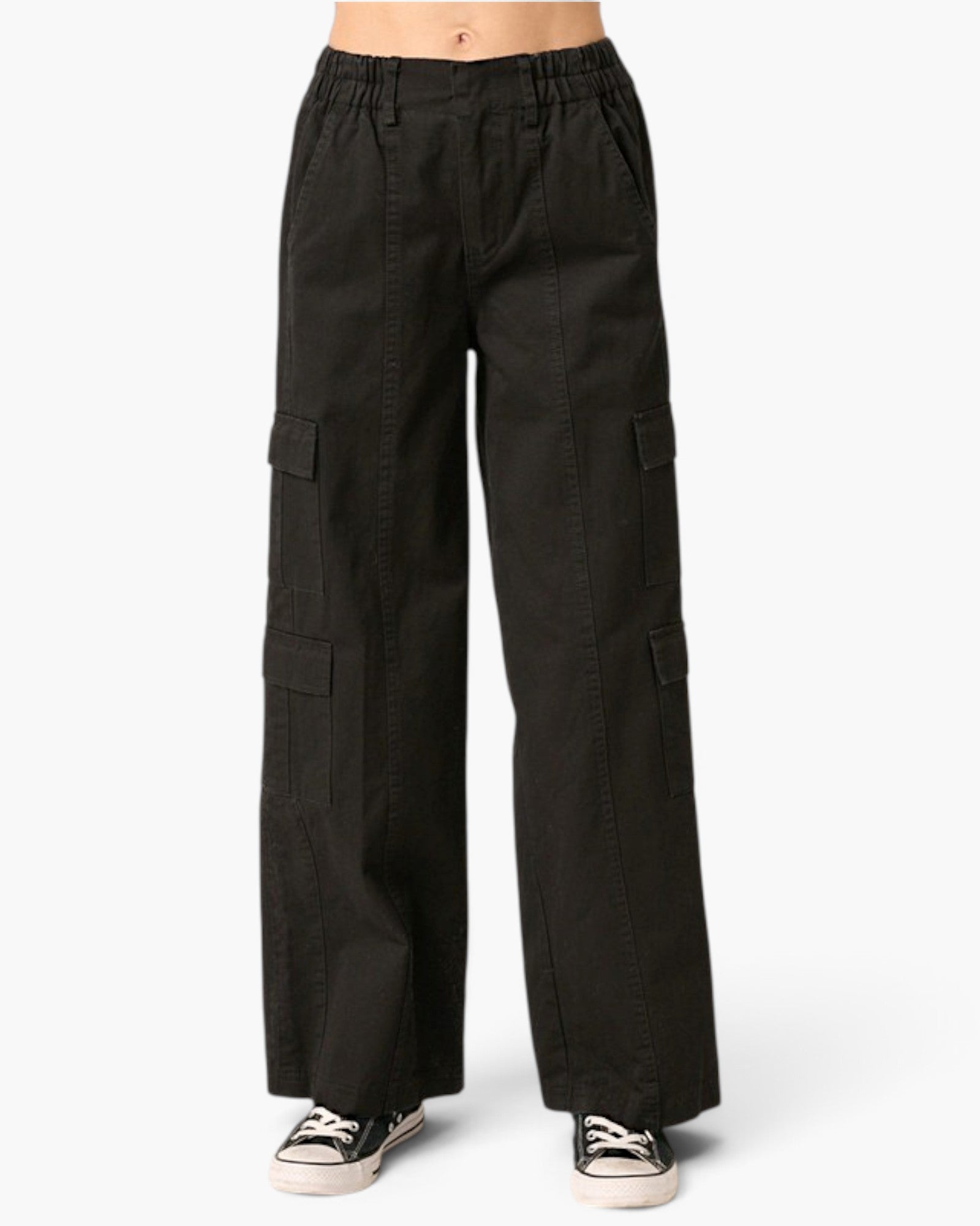 Black wide-leg cargo pants with an elastic waistband, modeled from the waist down with black and white sneakers against a light gray background.