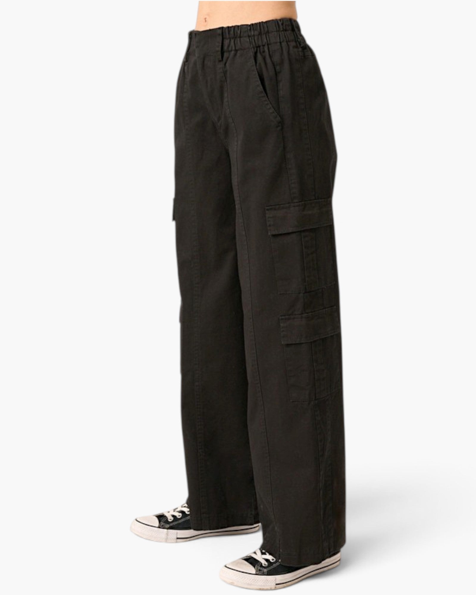 Black wide-leg cargo pants with an elastic waistband, modeled from the waist down with black and white sneakers against a light gray background.