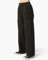 Black wide-leg cargo pants with an elastic waistband, modeled from the waist down with black and white sneakers against a light gray background.