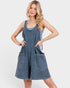 Woman wearing a denim dress on a white background