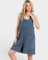 Woman wearing a denim dress on a white background