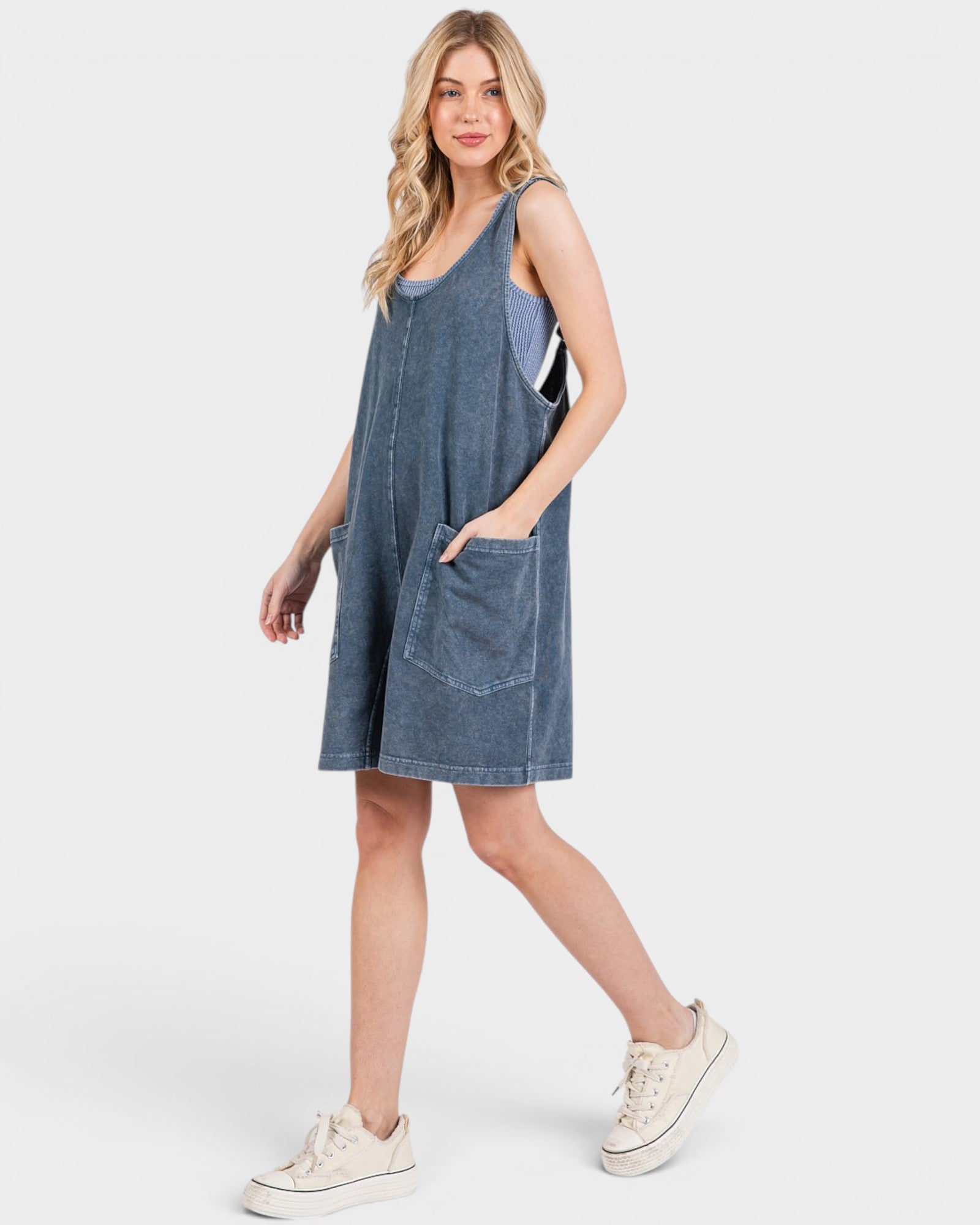 Woman wearing a blue denim dress on a white background