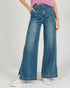 Person wearing blue wide-leg jeans on a plain background