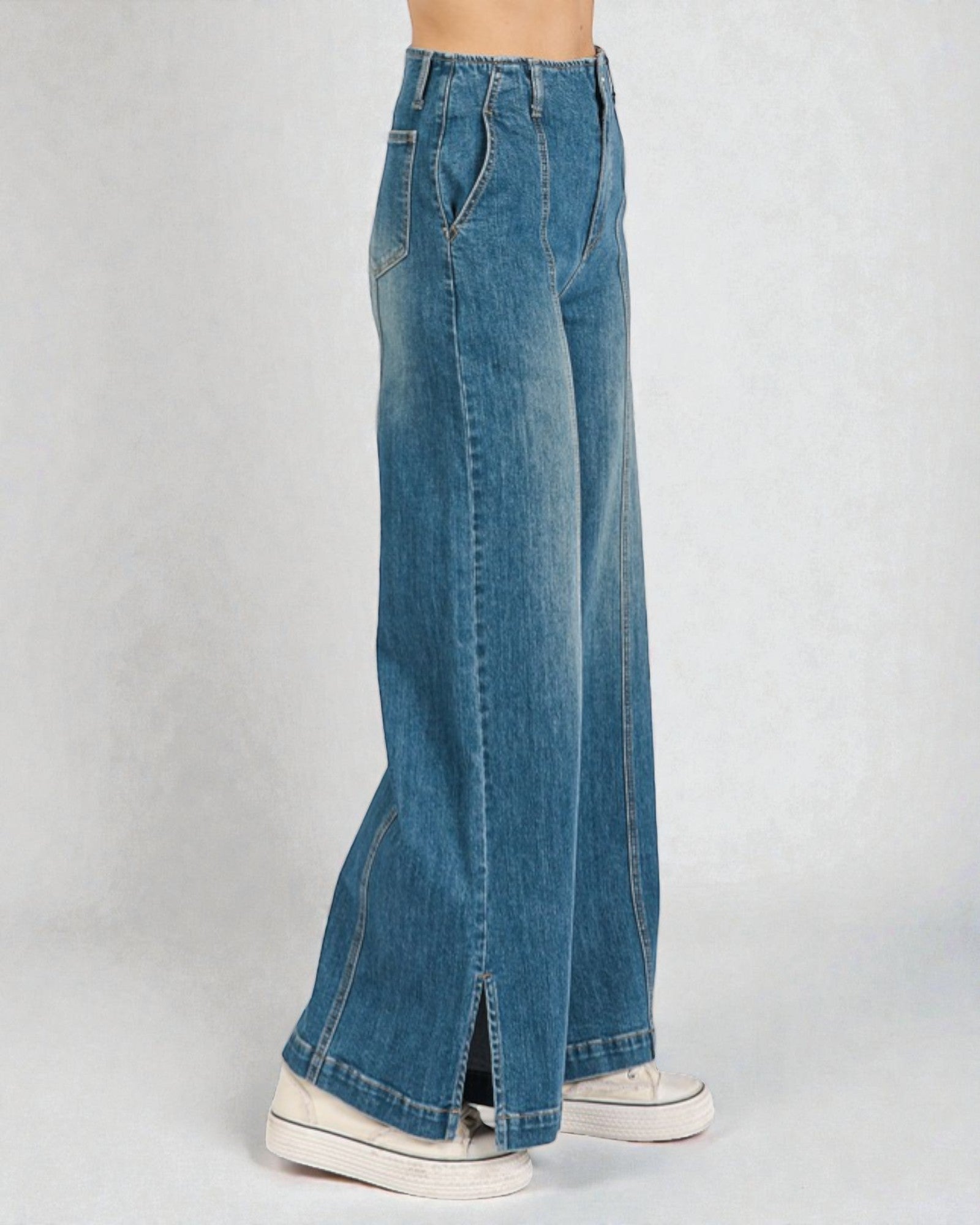 Blue jeans worn by a person on a white background