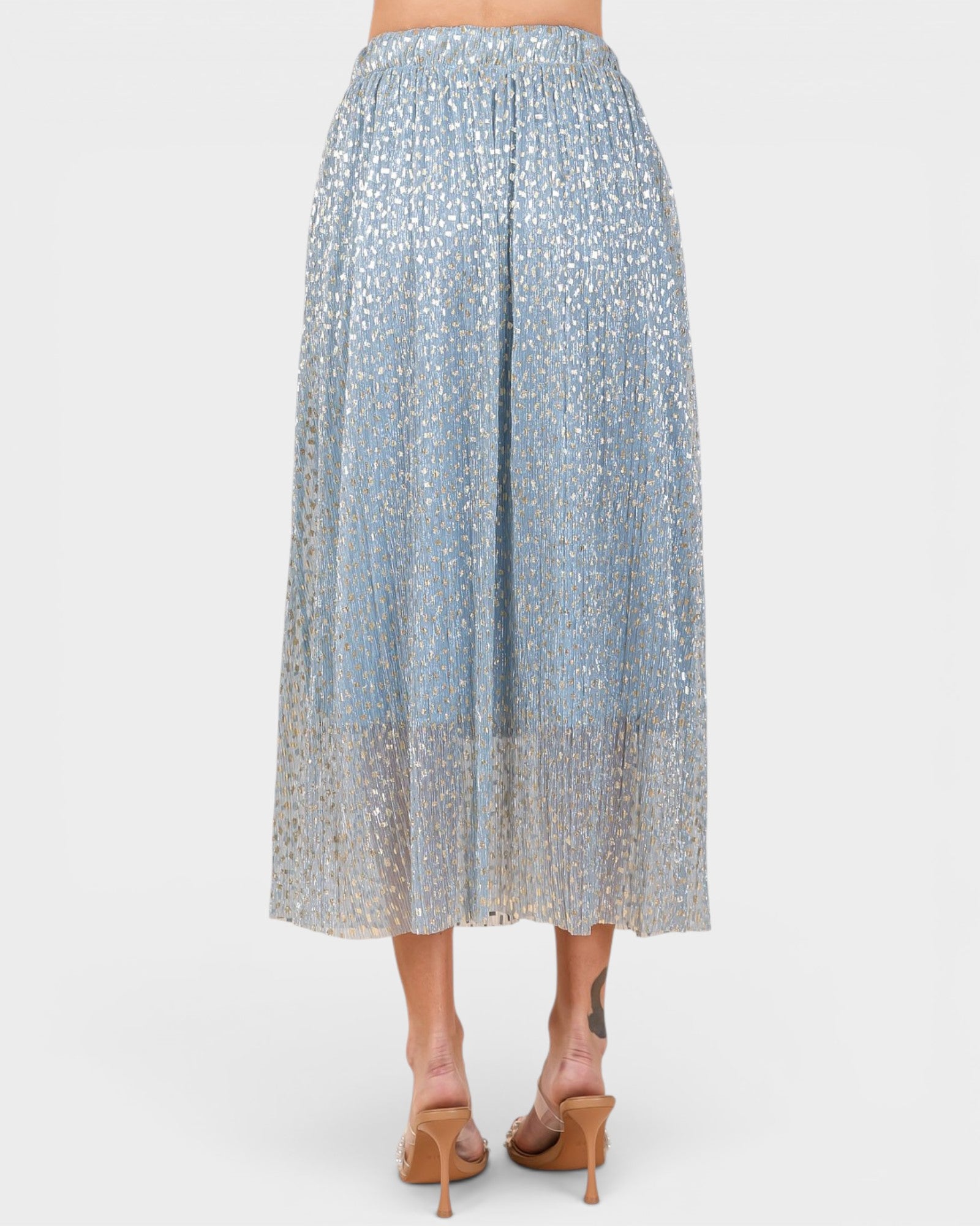 Light blue patterned skirt worn by a person on a white background