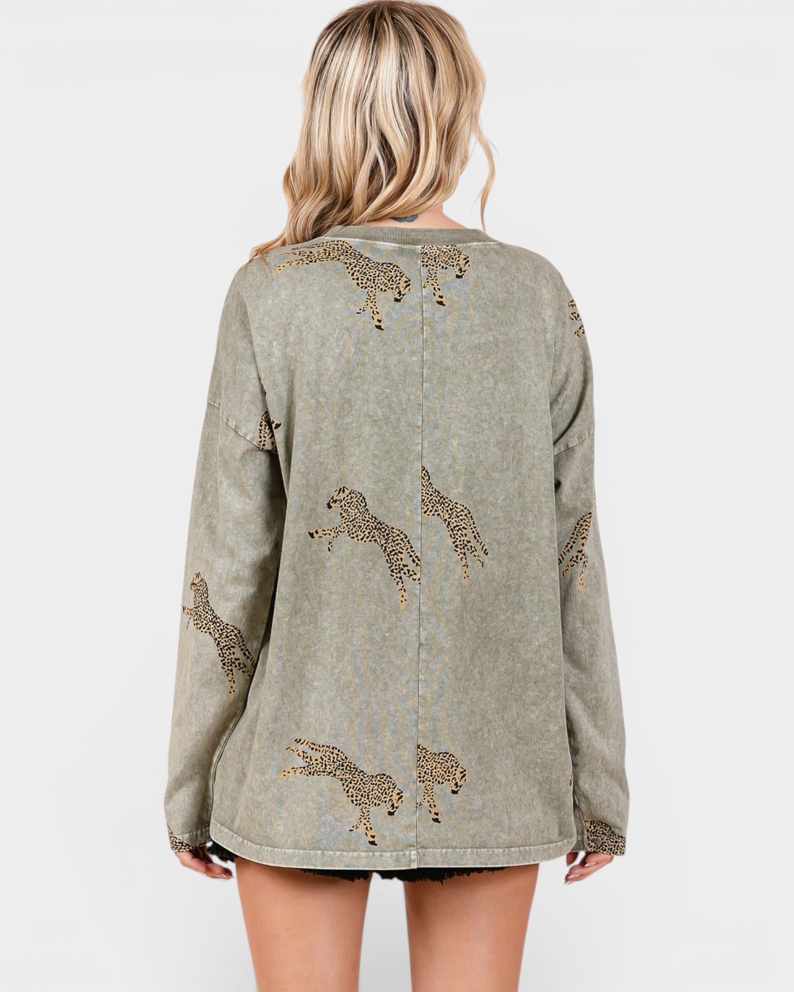 Green jacket with animal embroidery on a plain background