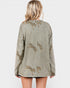 Green jacket with animal embroidery on a plain background