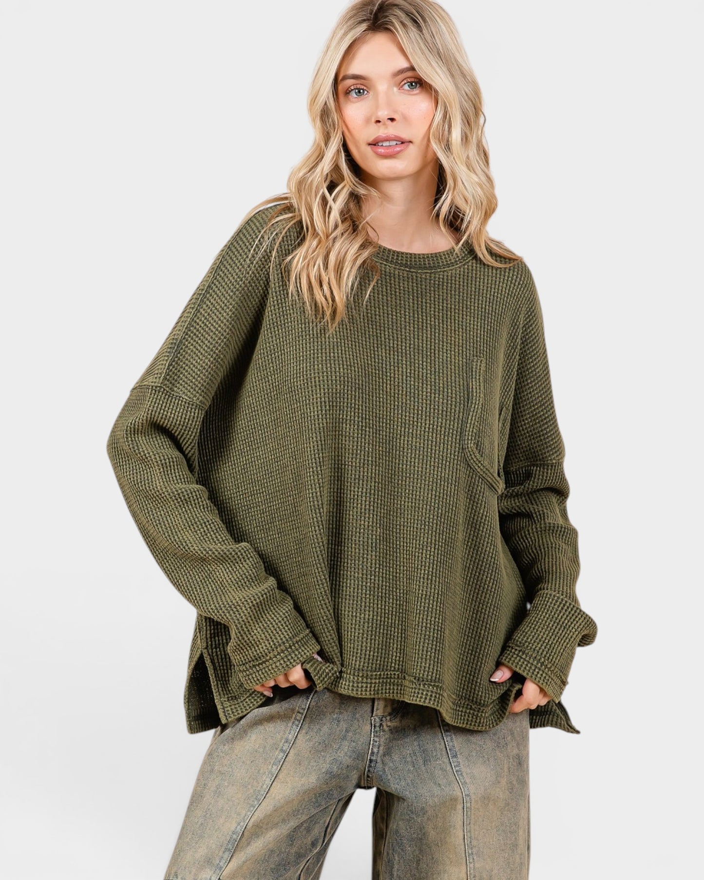 Woman wearing an olive green sweater on a white background