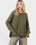 Woman wearing an olive green sweater on a white background