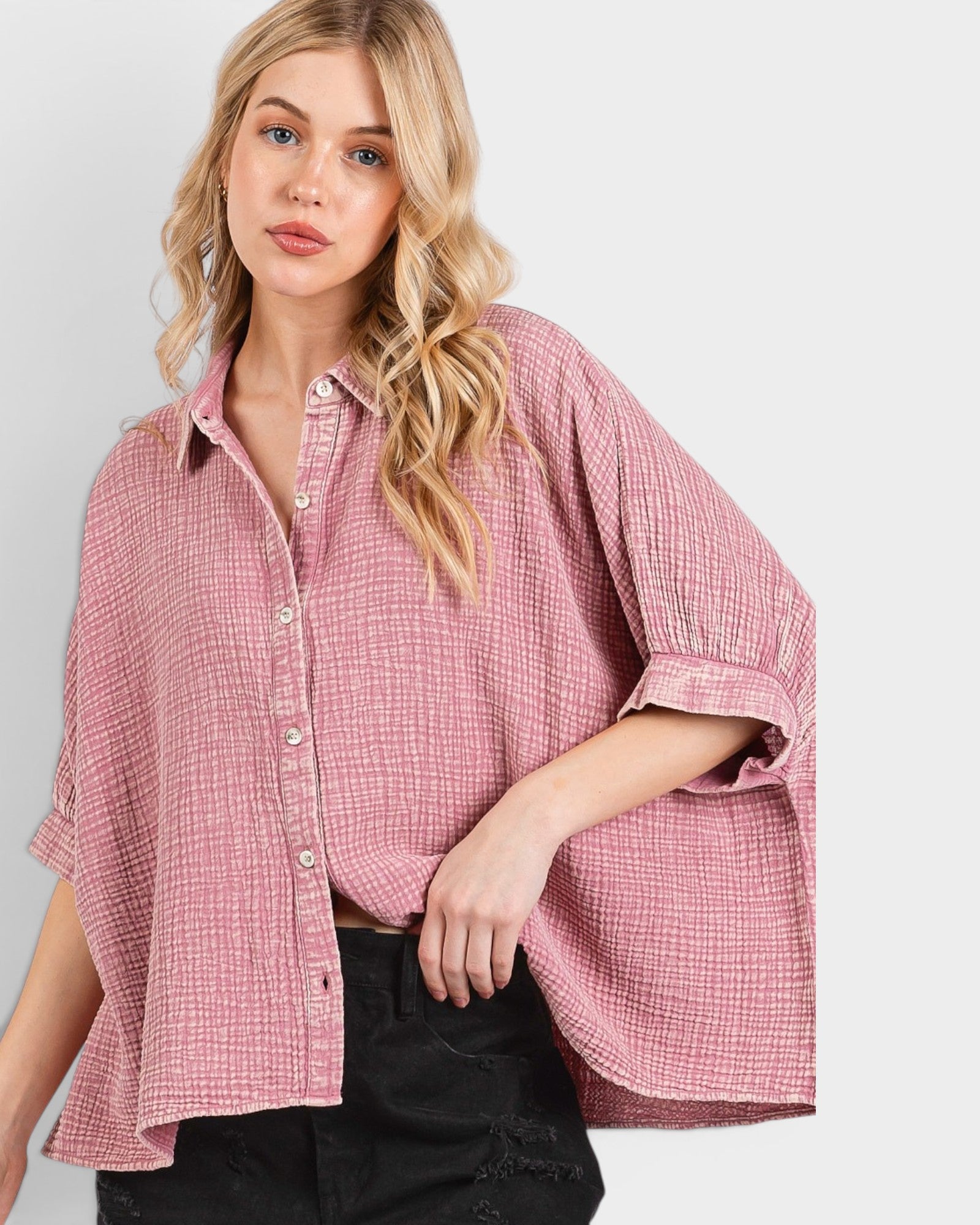 Woman wearing a pink checkered shirt on a plain background