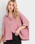 Woman wearing a pink checkered shirt on a plain background