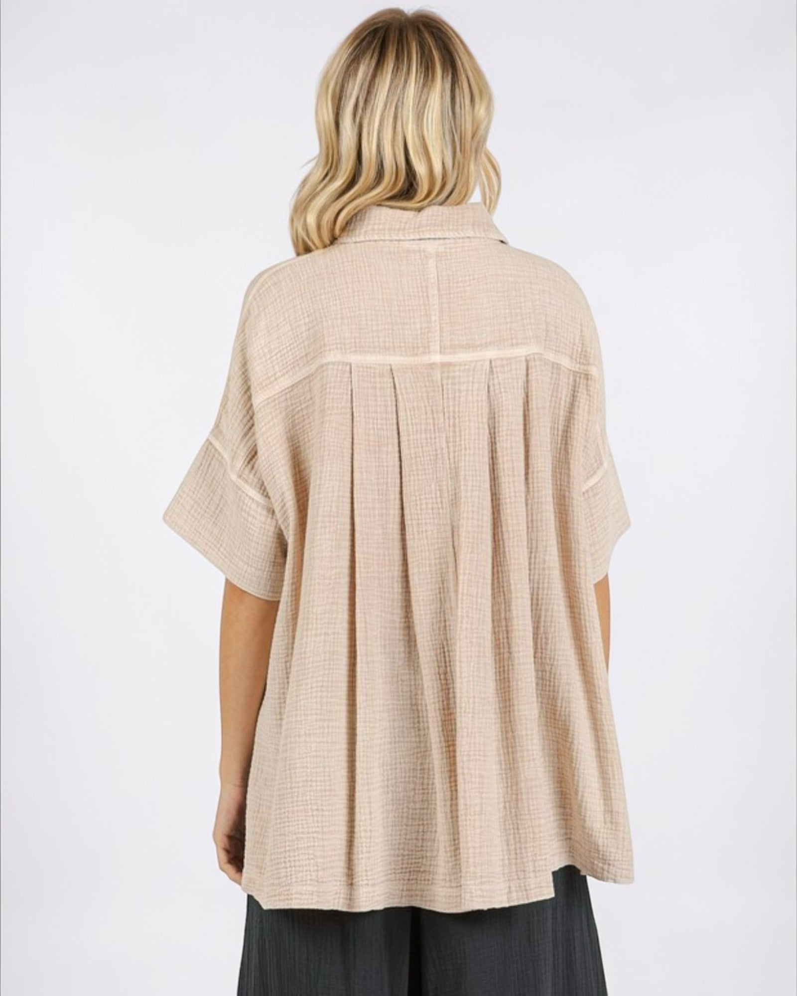 Woman wearing a beige checkered shirt on a white background