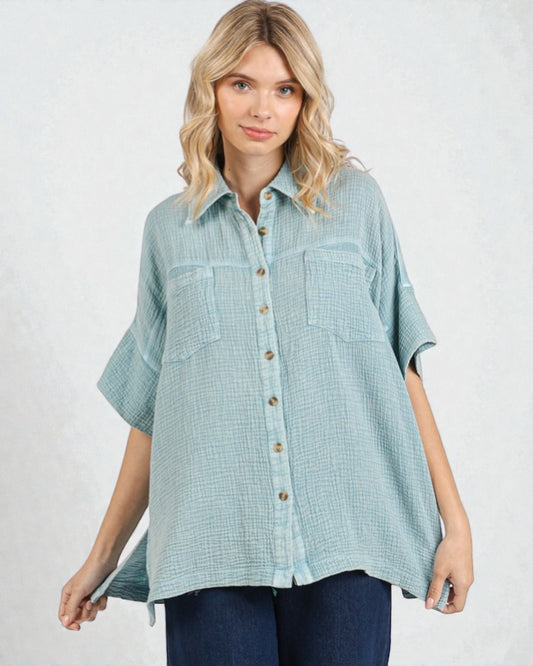Woman wearing a light blue checkered shirt on a white background