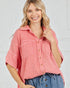 Woman wearing a pink checkered shirt with a white background