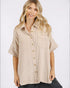 Woman wearing a beige button-up shirt on a white background