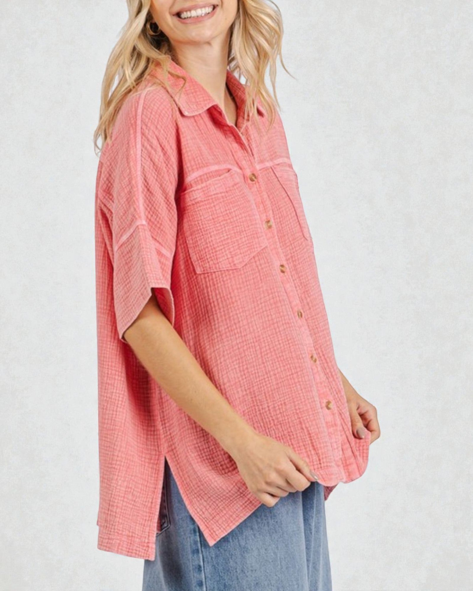 Woman wearing a pink checkered shirt with short sleeves on a white background