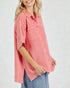 Woman wearing a pink checkered shirt with short sleeves on a white background