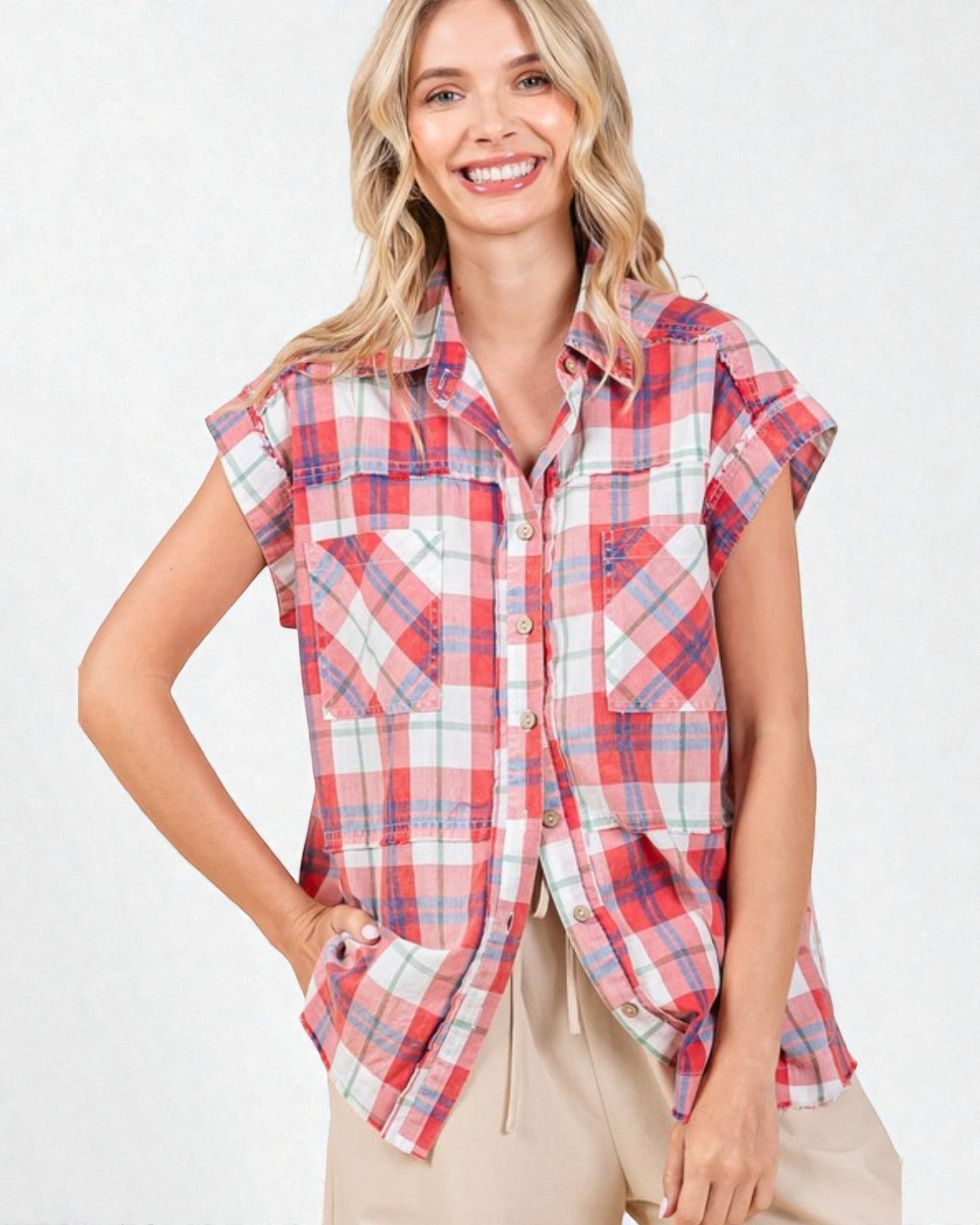 Woman wearing a red and white plaid sleeveless shirt on a white background